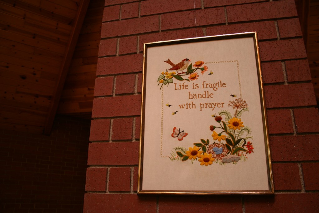 This same hand-embroidered art, displayed in church, hangs above my bed.