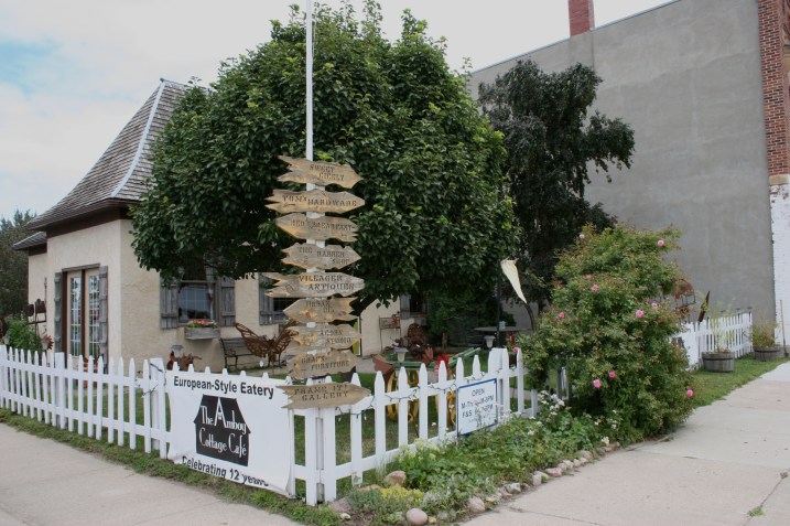 Signage on the fence at The Amboy Cottage Cafe lists downtown businesses.