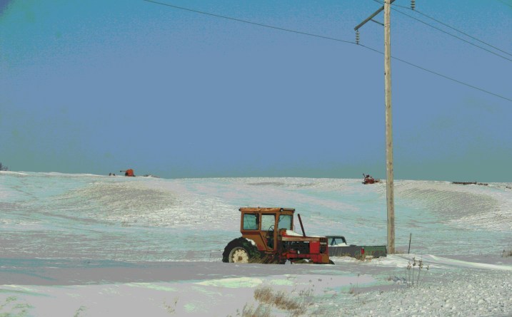 Machinery, seemingly abandoned in the snow.