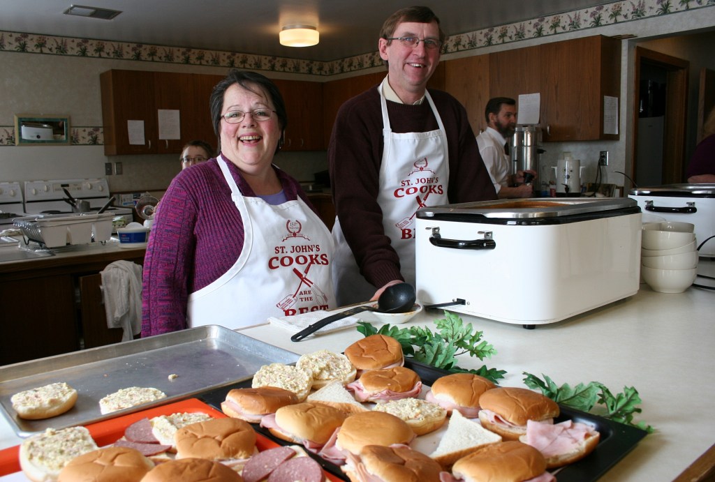 Kim and Keith serve diners.