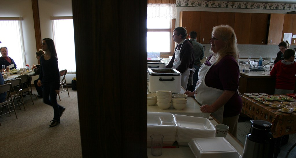 Lynn, right, tends the potato soup in this duo scene of kitchen and fellowship hall.