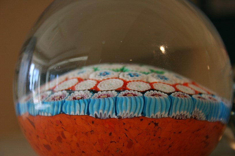 A close-up side view of a paperweight.