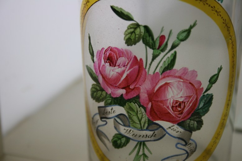 Detailed floral art on glassware.