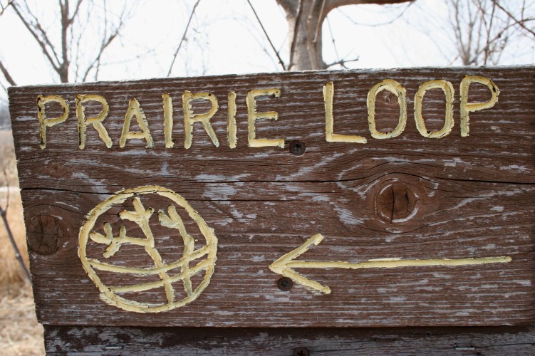 Handcrafted signs guide visitors along trails.