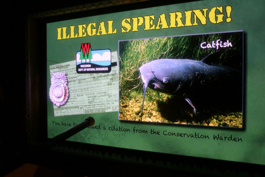 In an interactive portion of the exhibit, in a fish house, visitors can try spearing a sturgeon. In this case, my daughter "speared" a catfish instead.