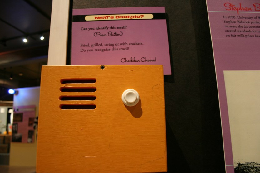 Via museum magic, you can actually press the button and smell cheddar cheese wafting from the golden box.