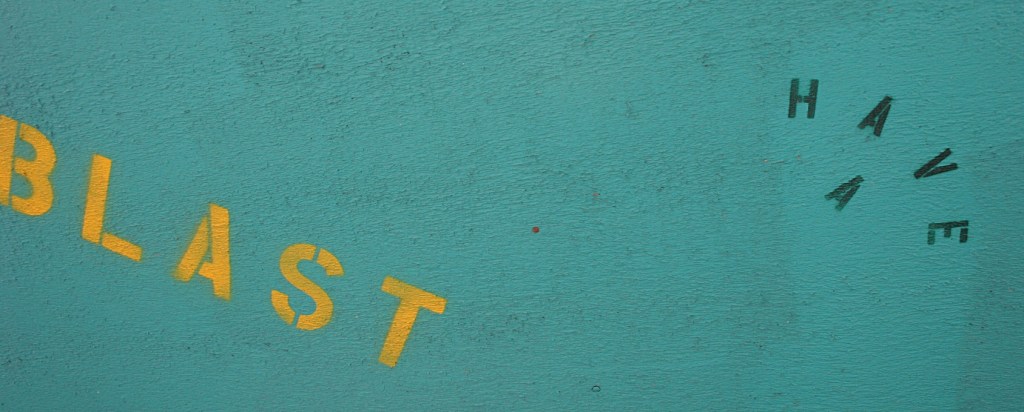 Stenciled on the roof overhang above the serving windows.