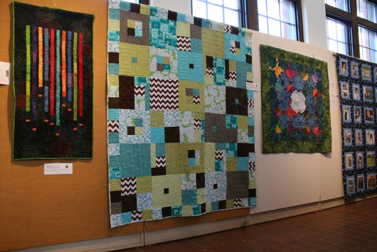 Quilt art lines a hallway.