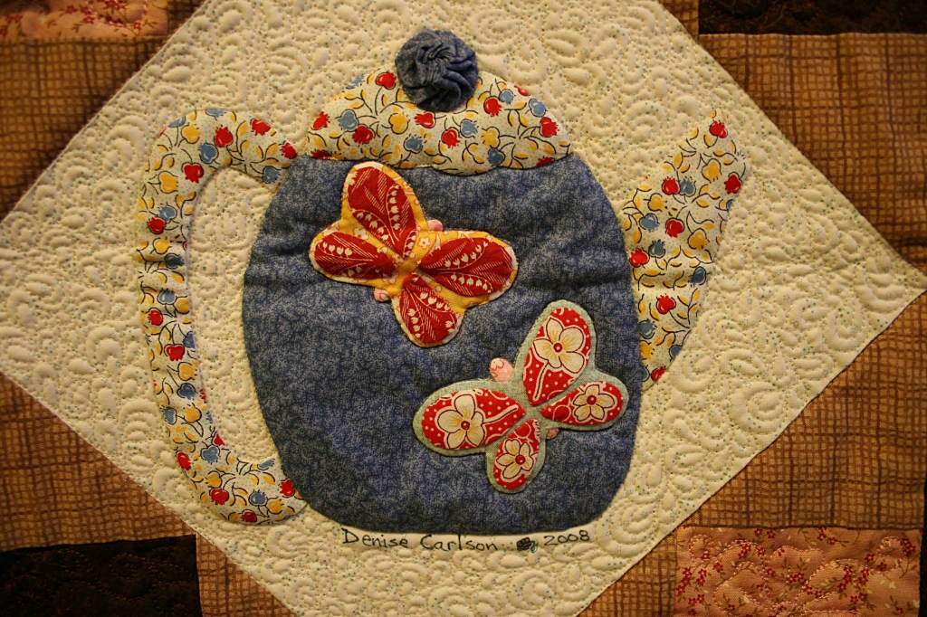 A block in a teapot themed quilt.
