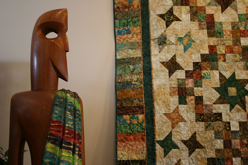 I really liked this pairing of wood sculpture with quilt art. The wood tone compliments the earthy colors of the quilt.