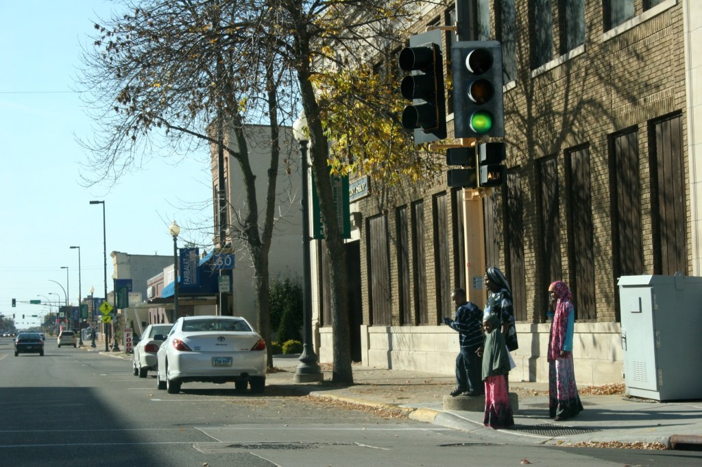 A Somali family waits to cross a street in downtown Faribault. Minnesota Prairie Roots file photo 2010.