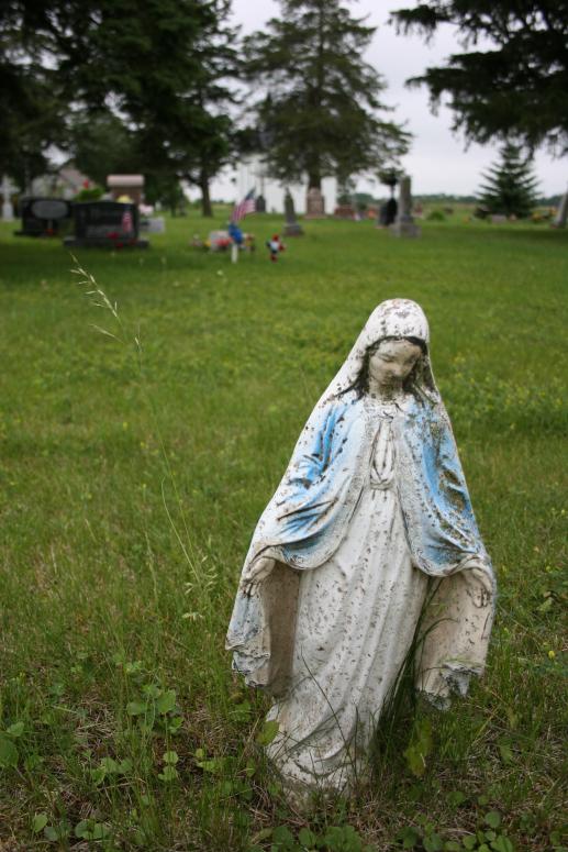 A compelling statue of the Virgin Mary in Trebon Cemetery.