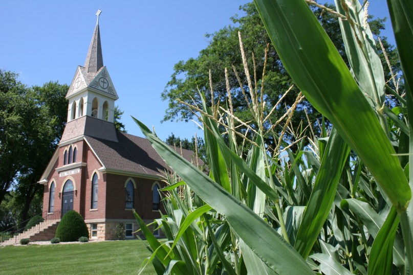 Fields and a cemetery embrace many country churches like Vista Evangelical Lutheran Church in southern Minnesota.