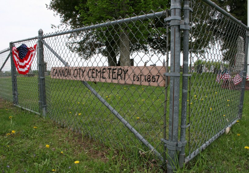 The cemetery fence decorated for Memorial Day.