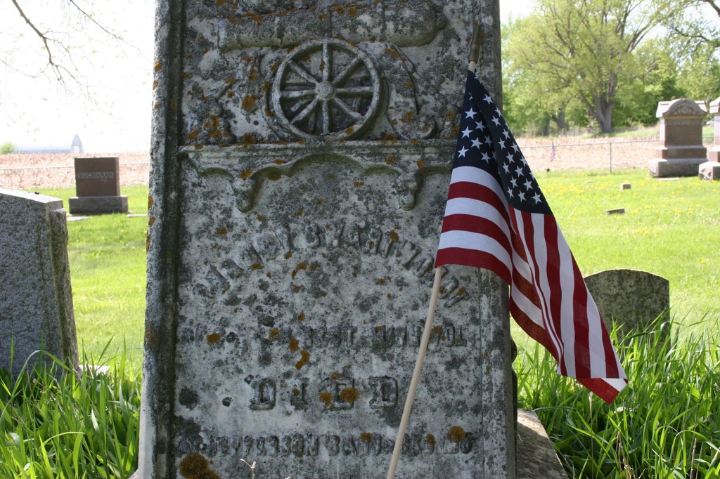A soldier's grave, flagged for Memorial Day.
