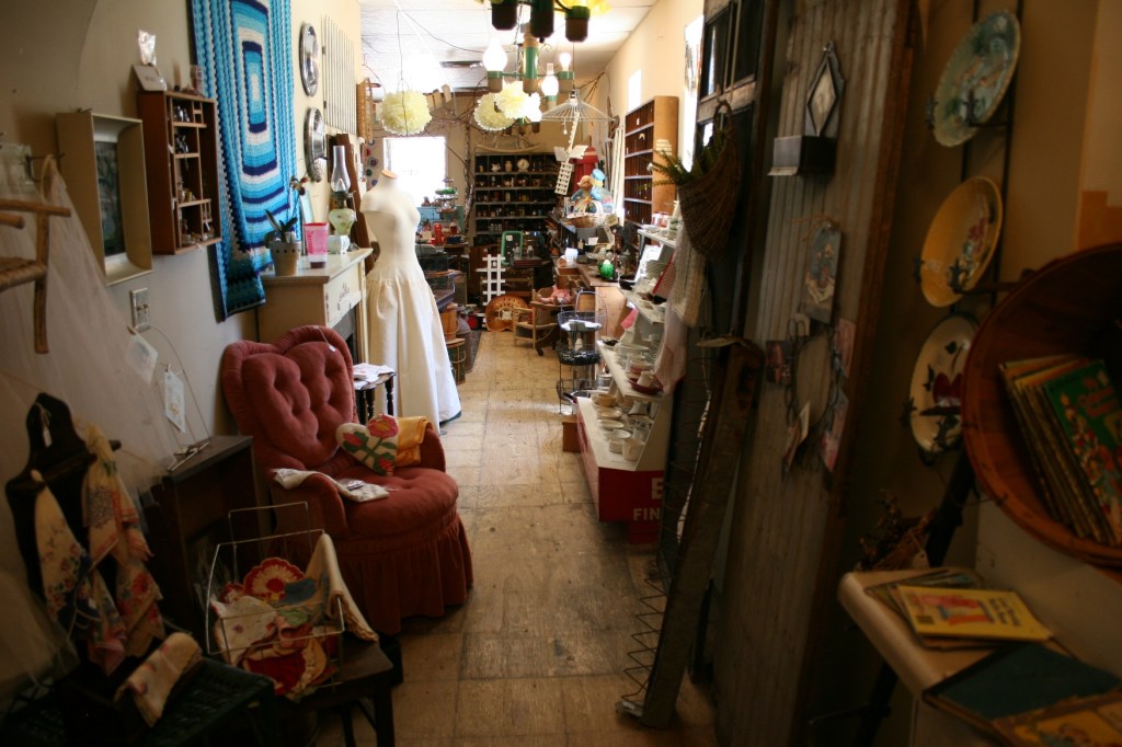 The narrow space that connects the front of the shop to the back.