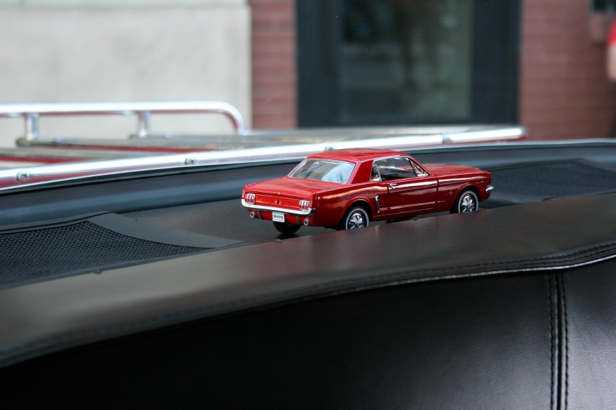 Details: a toy Mustang in a rear window.