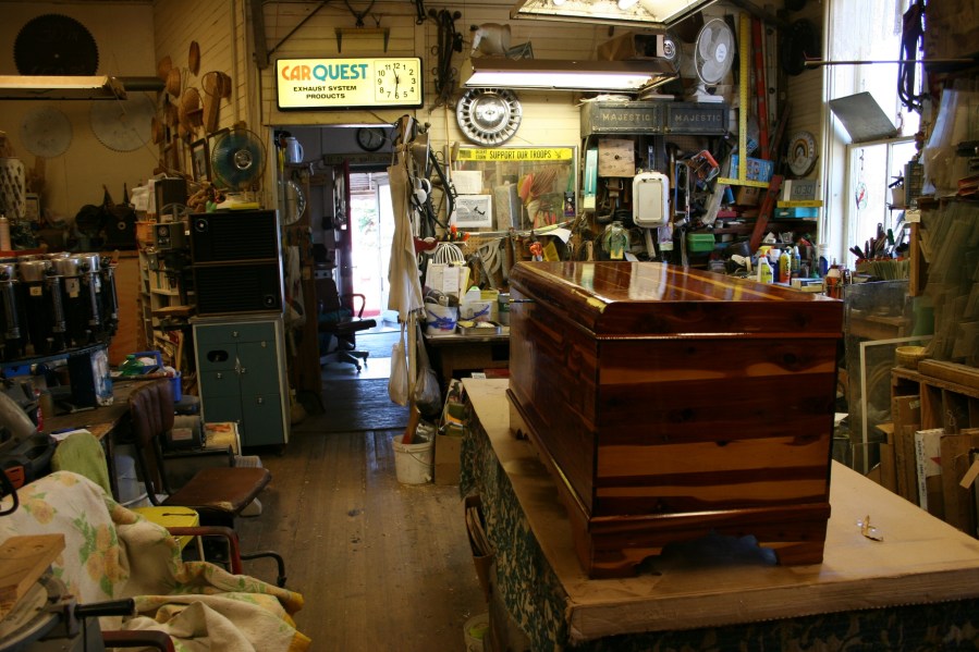 Be careful what you touch. The varnish on this trunk was still drying when I visited. Table saws are set up about mid-way through the store for Wayne's woodworking projects.