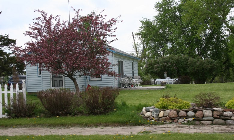 Another beautiful home with a lovely landscaping that includes field rocks.