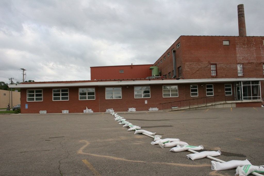 Sandbags hold down a pipe at the Faribault Woolen Mill factory and retail store.