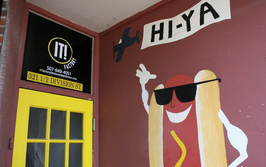 A kitschy painting outside a business entry.