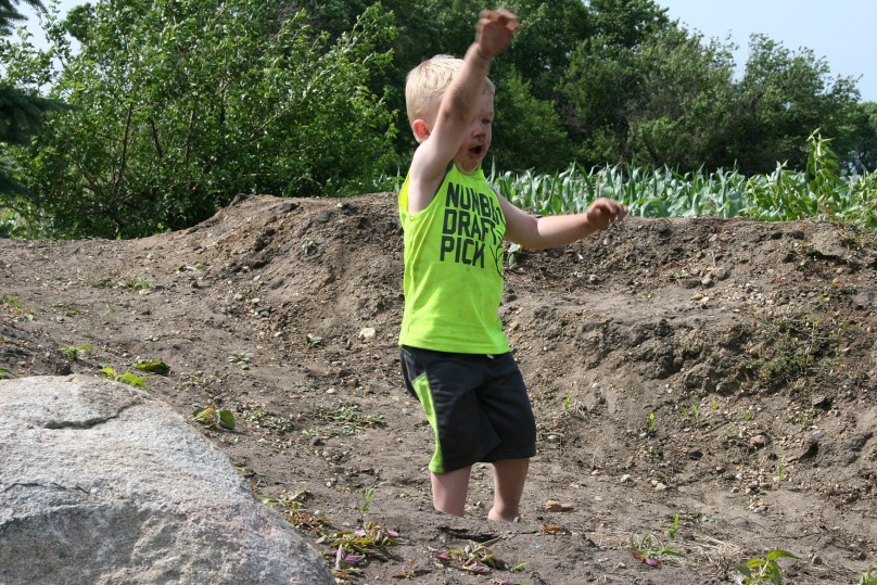 Boy throwing dirt