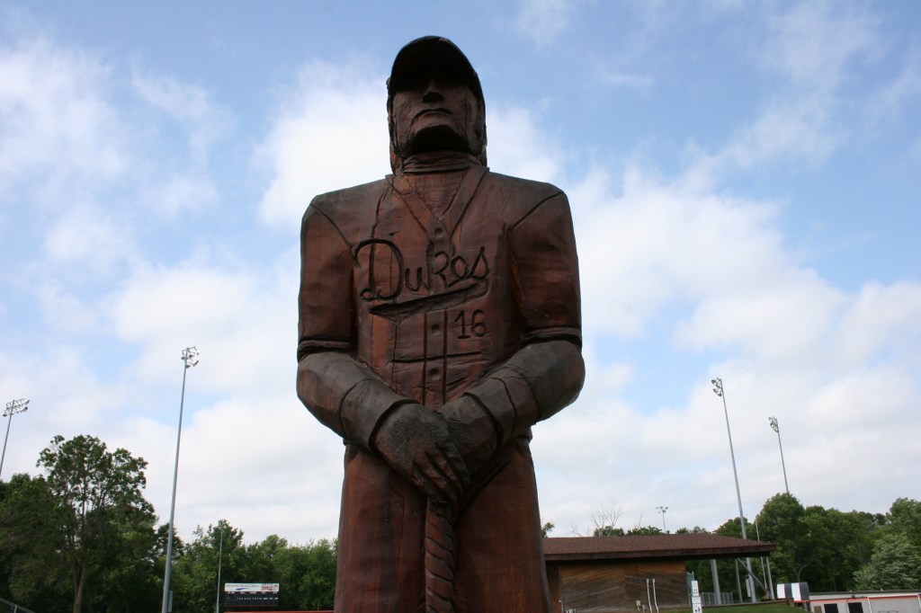 A carving of a Dundas Dukes baseball player stands just outisde the baseball field in Dundas.