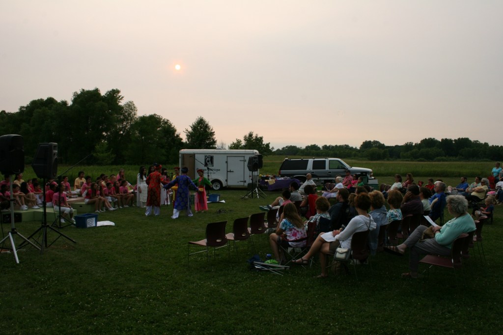 As the sun sets, performers in traditional Vietnamese attire present selections from Vietnam.