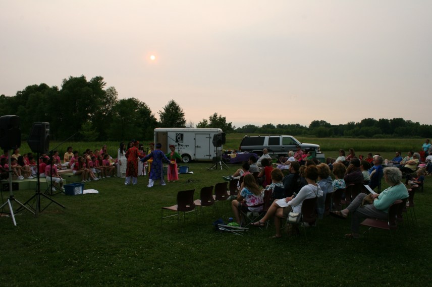 As the sun sets, performers in traditional Vietnamese attire present selections from Vietnam.