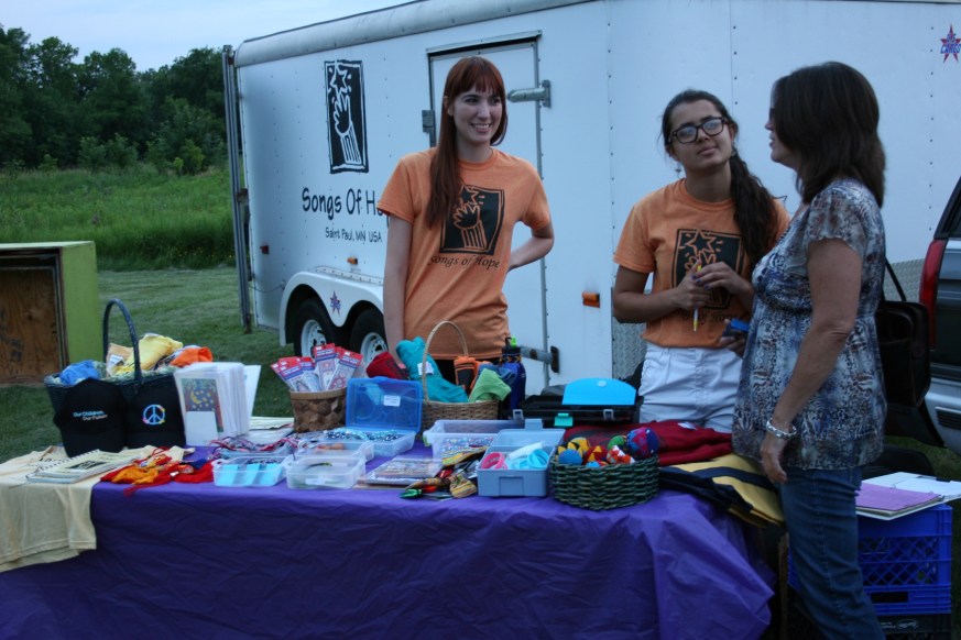 After the concert, goods from various countries and more were available for purchase. The young woman on the left is a native of Argentina who works as an opera singer in France. She's in the U.S. for a month with Songs of Hope.