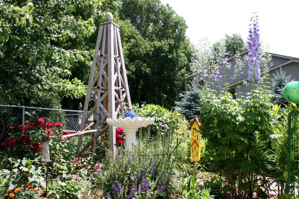 The side yard garden featuring Dale's handcrafted trellis sculpture.