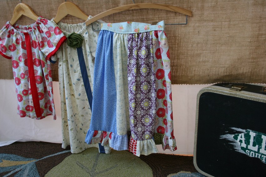 Some of Derrin's creations displayed next to a vintage suitcase in the porch.