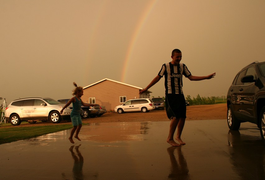 My nephew and great niece dance in the rain.