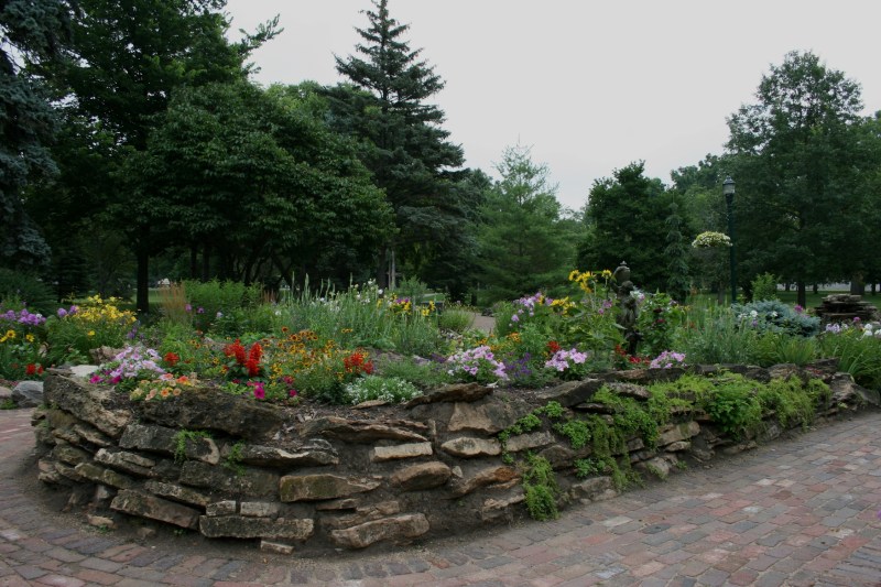 The garden includes a fountain tucked among the flowers.