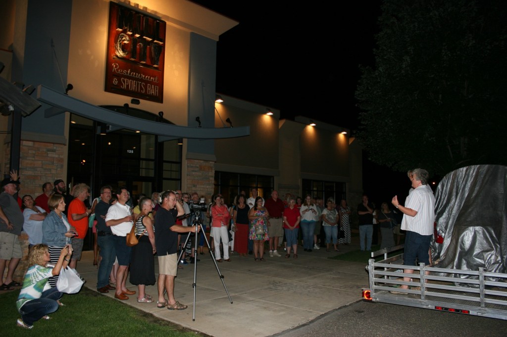 Celebrating the restoration and reveal of the 1950s Tilt-A-Whirl car outside Mill City Restaurant.