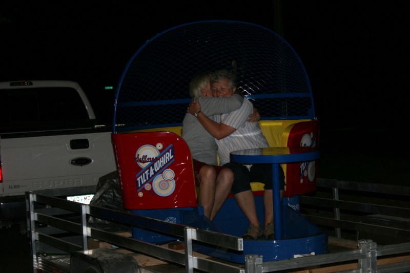 Tami Schluter, left, and Peggy Keilen embrace after unveiling the car.