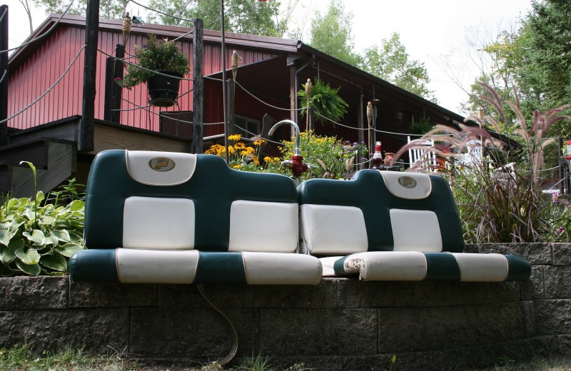 Boat seats repurposed as a seating area on a retaining wall.