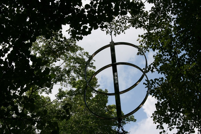 A snippet of an art piece dangling high in the trees.