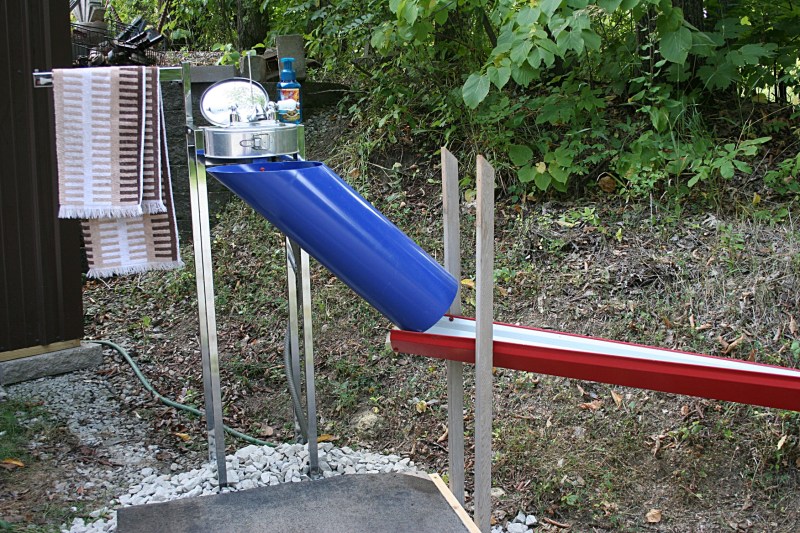 A portable outdoor functioning sink created with old faucets, springform pan, plastic pipes and more.
