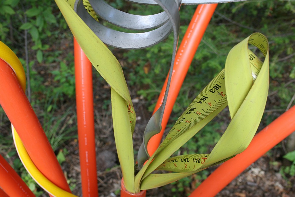 Even old tape measures are worked into his art.