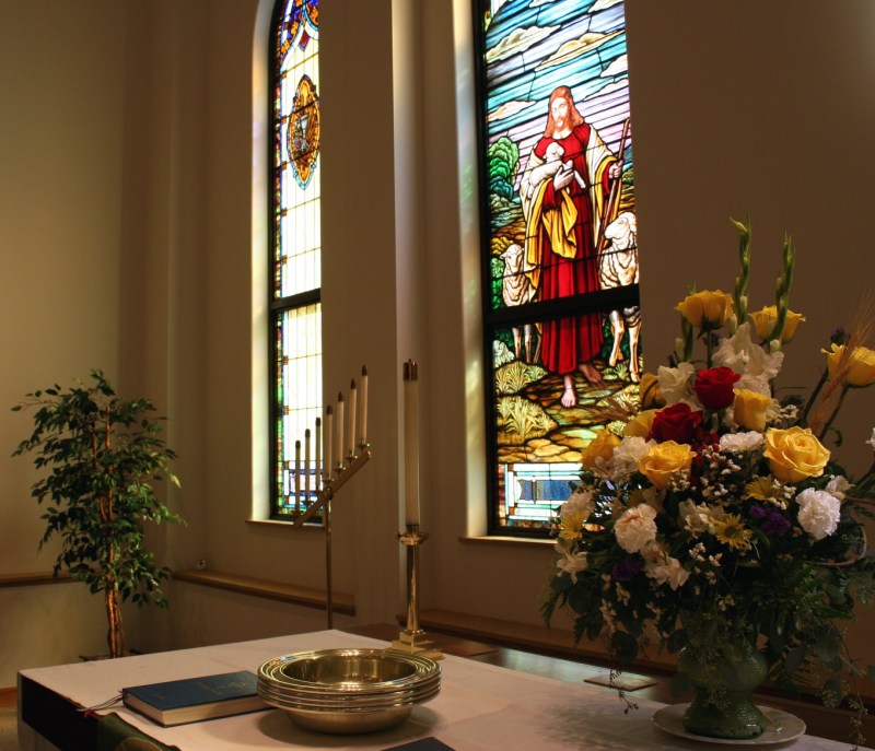 Beautiful aged stained glass windows highlight the sanctuary.