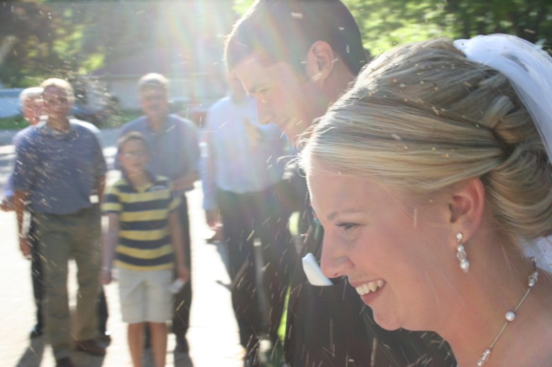 Carlyn and Jared leave the church in the early evening, showered with birdseed.