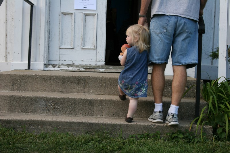 Dad and daughter enter the historic church.