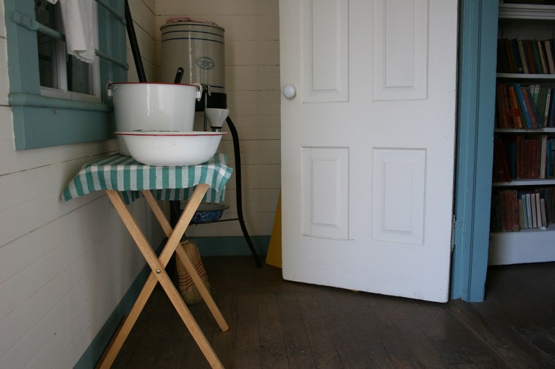 Wash basin and water cooler inside the schoolhouse entry.