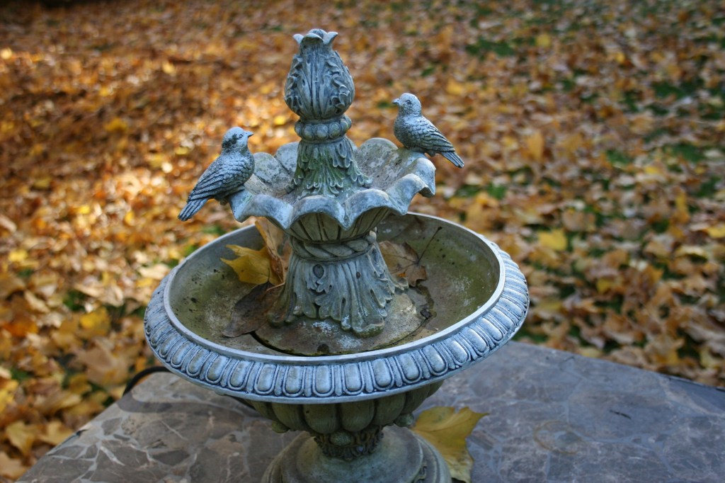 I'm in no hurry to rake the leaves in my backyard. This fountain rests on a patio table.