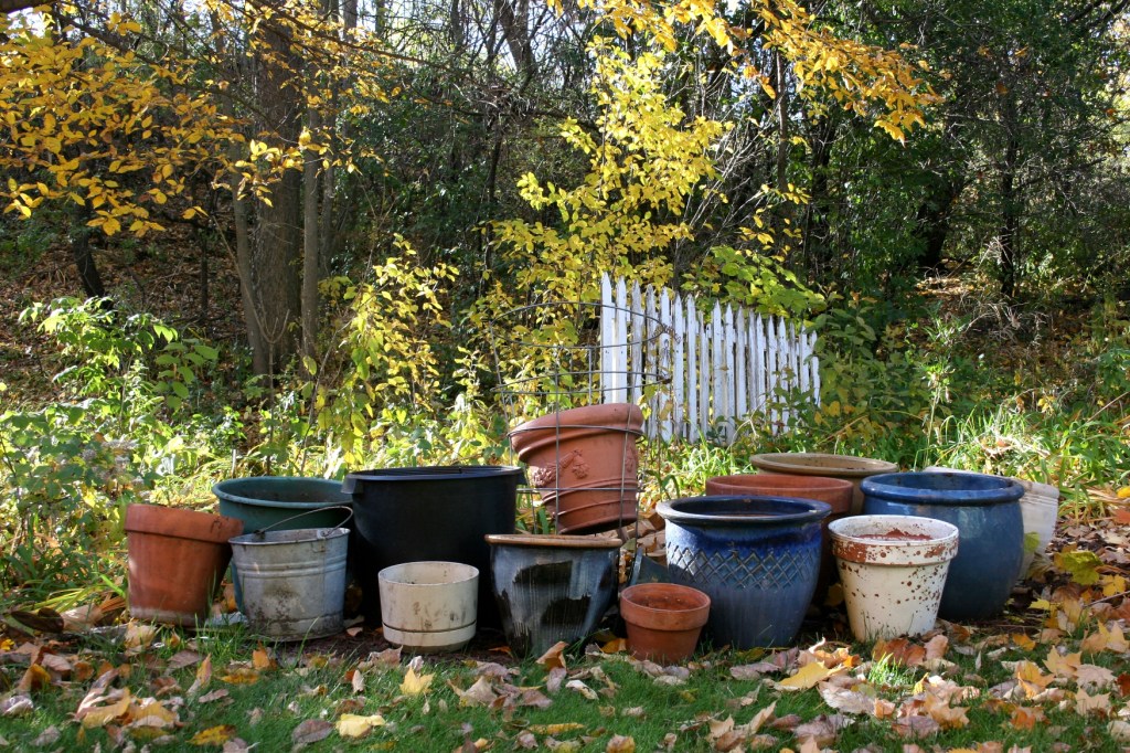 Flower pots are stacked, waiting to be stashed inside the garage.