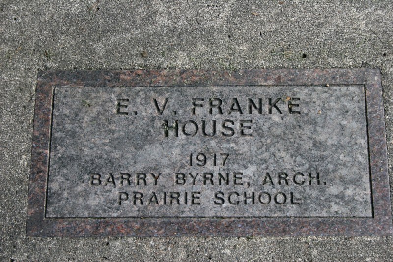 Signs embedded in the sidewalk identify some, if not all, of the Prairie School houses.