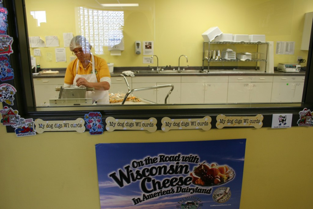 Customers can watch employees bagging cheese curds.