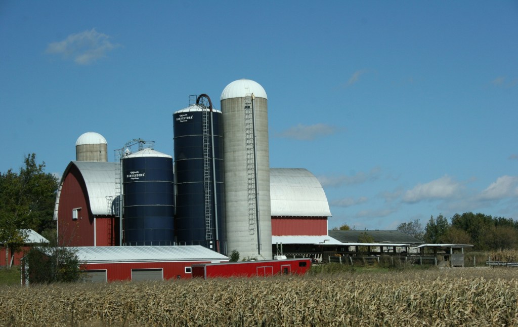 Rural, red barn and Harvestores