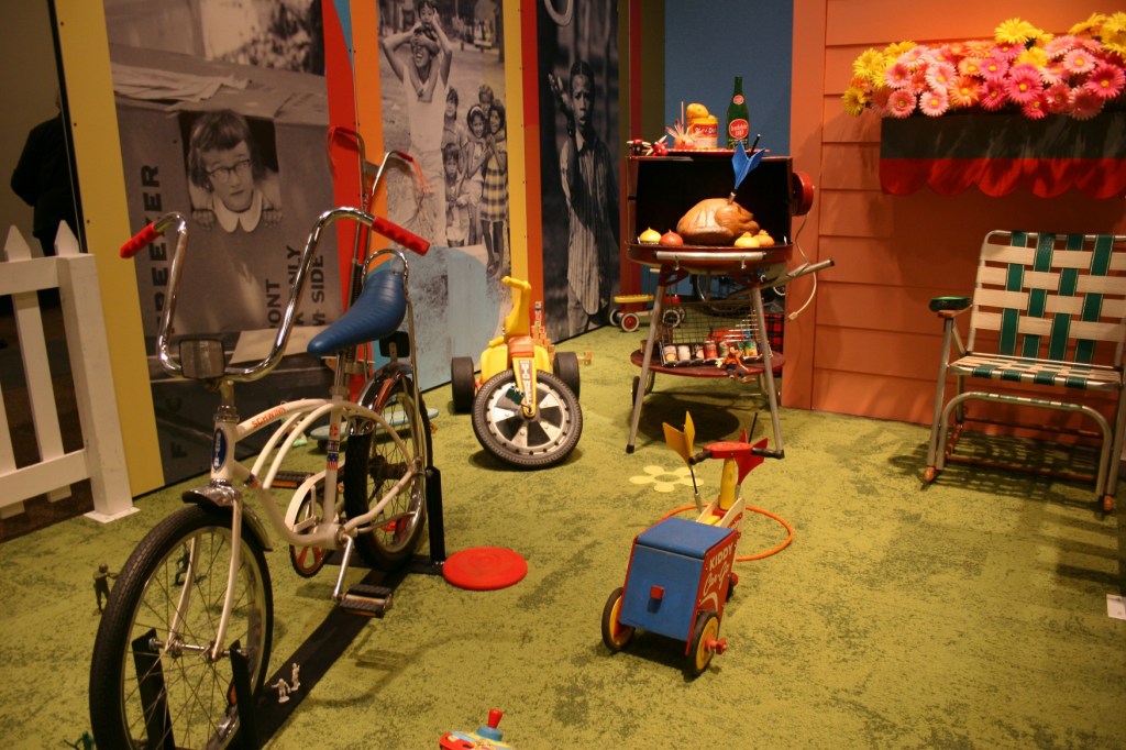 Outdoor toys and a play area are part of the exhibit.